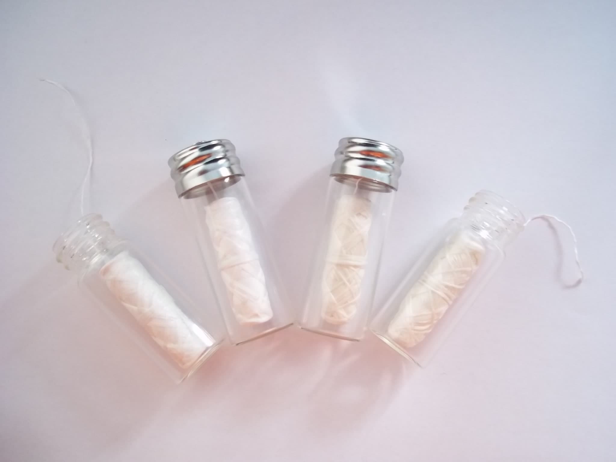 Natural silk dental floss with transparent glass bottle case